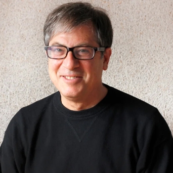 Headshot of Henry Myerberg in a black turtleneck with dark wireframed glasses