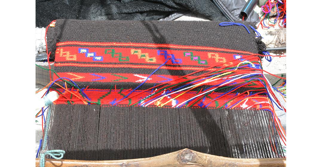 A traditional  Shawl being weaved in pit loom in the open 